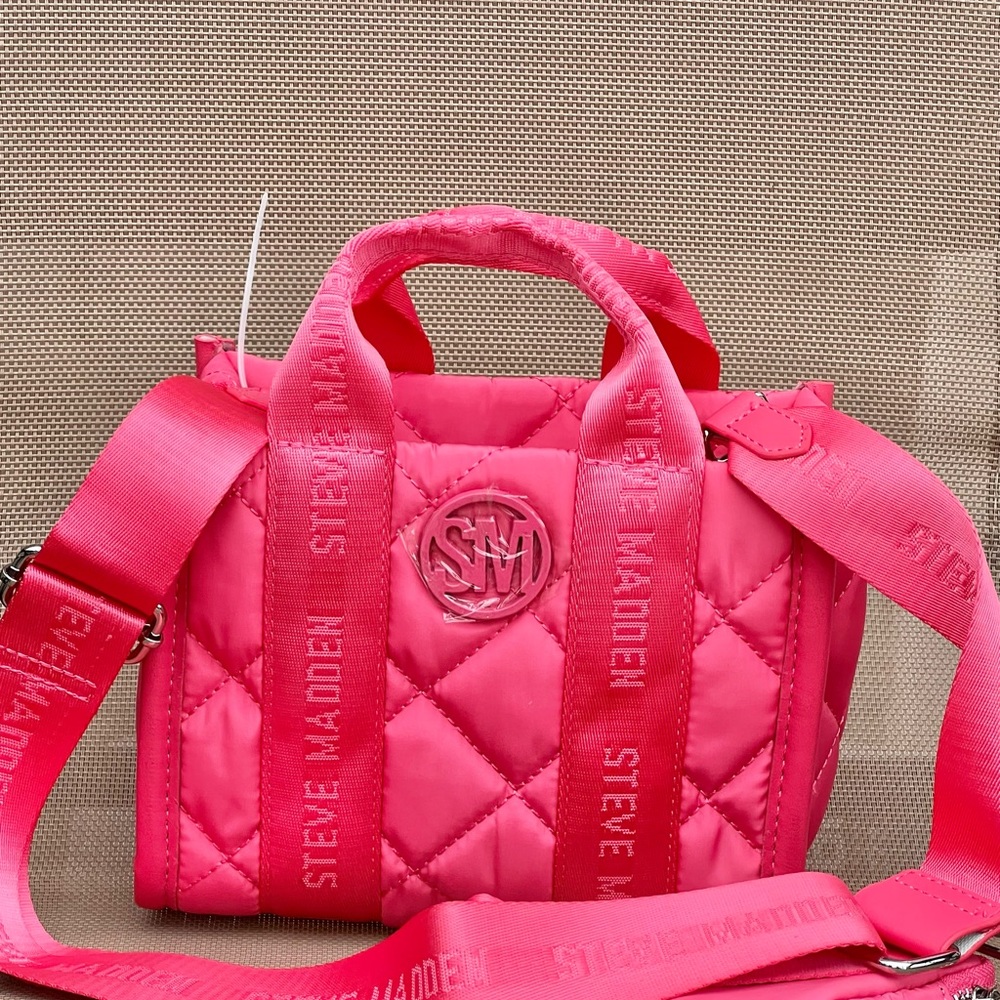 - Steve Madden Crossbody Purse TikTok Mini pink-ish/coral in color.